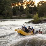 a group of people riding a raft down a river