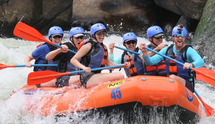 people riding orange kayak on river during daytime